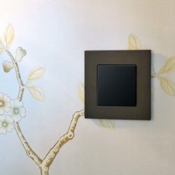 GIRA Esprit Dark Bronze light switch on patterned wall