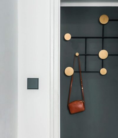 Jung Les Couleurs light switch in gris fonce in a hallway